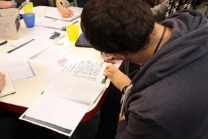 Attendee writing in a notebook on a Script to Screen project workshop